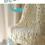 cream arm knit blanket draped over chair