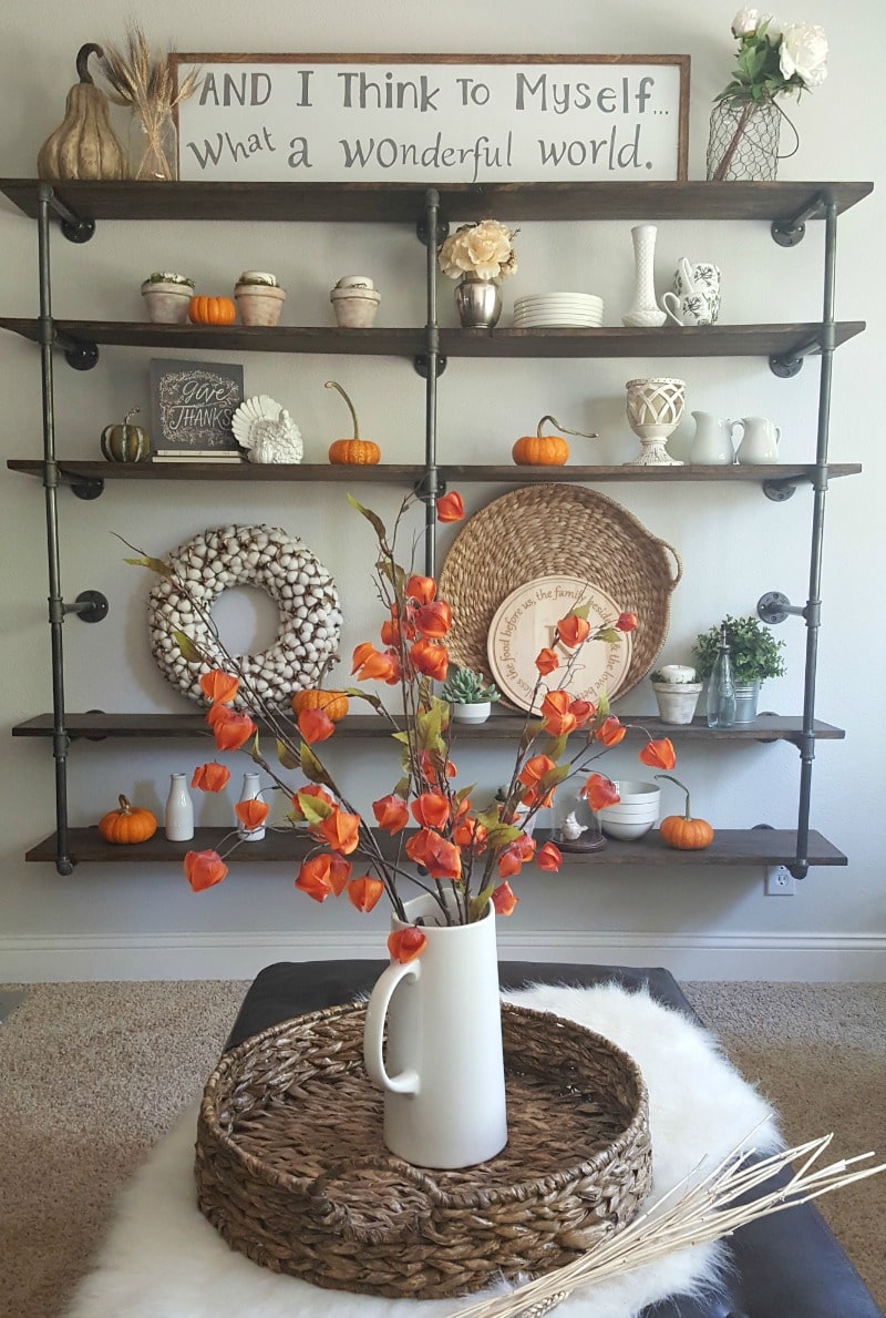 Pumpkins and orange to decorate pipe shelves for fall