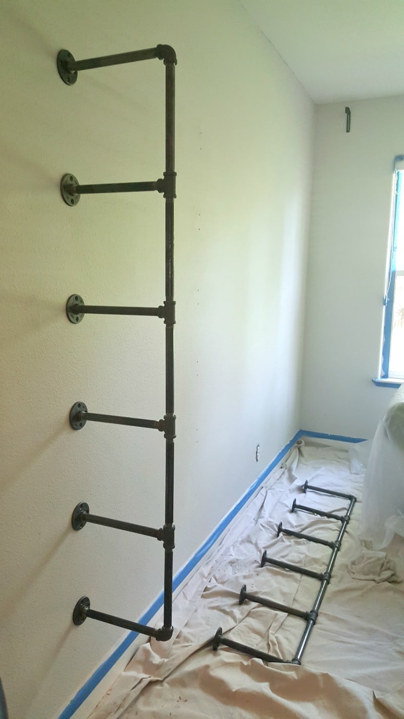 installation process attaching wall brackets for diy pipe shelves