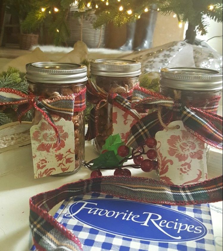 Mason jars filled with homemade ginger spiced nuts tied with plaid bows