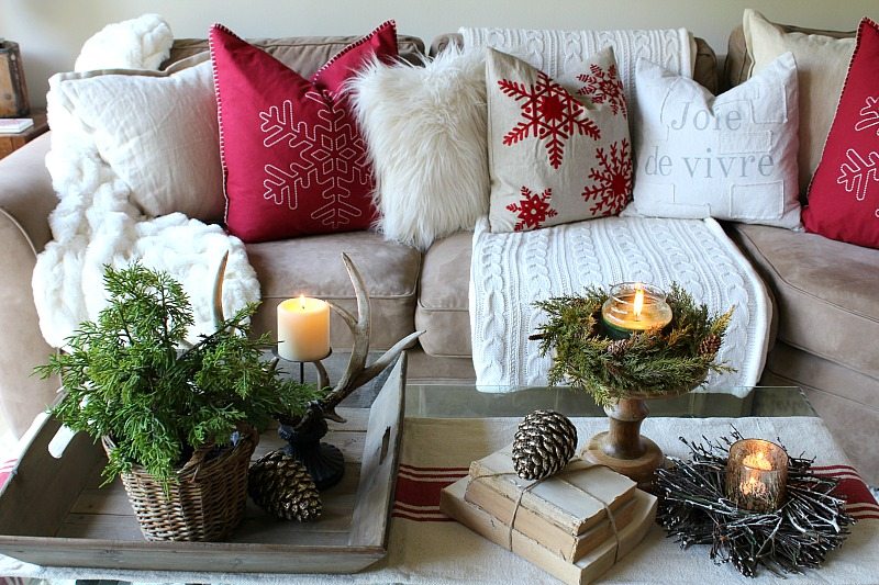 Rustic farmhouse coffee table with festive touches and holiday pillows