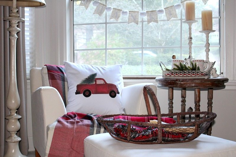 Master bedroom decor is holiday ready with traditional reds, pillows and tartan