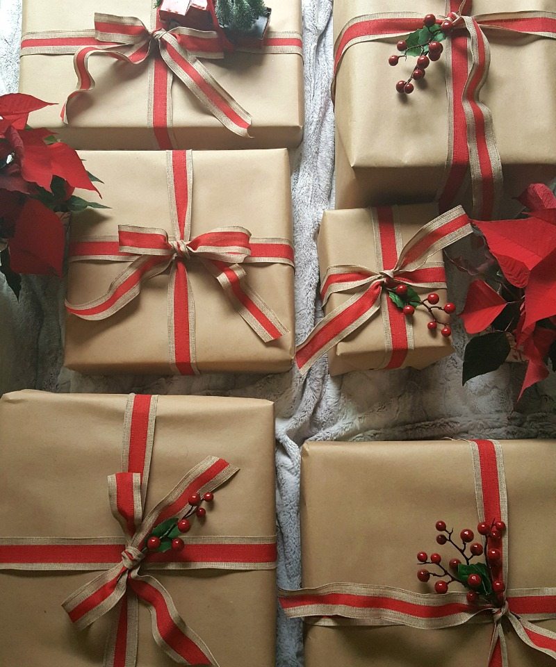 brown paper packages with red ribbon and holly