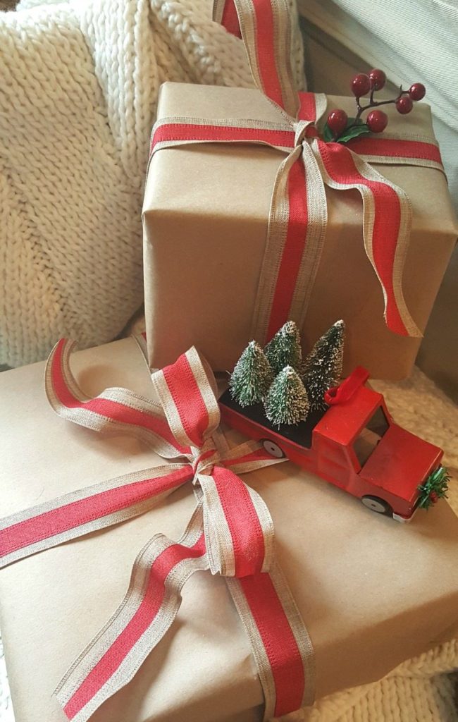 brown paper packages with red truck and trees