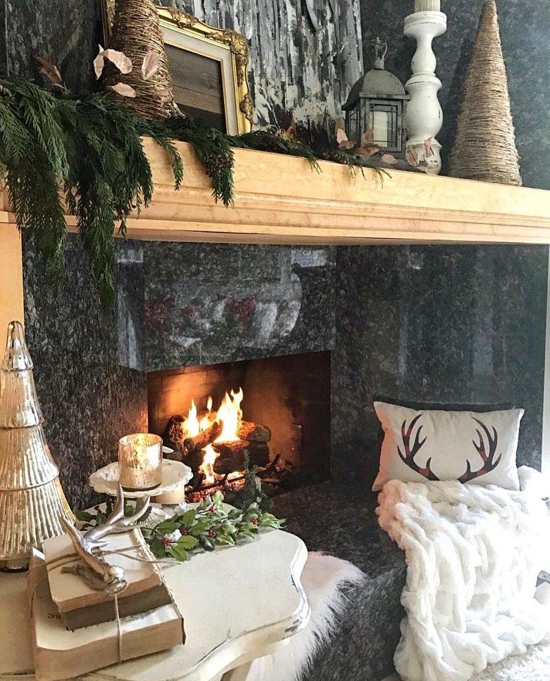 cozy warm inviting fireplace with pillows and throw