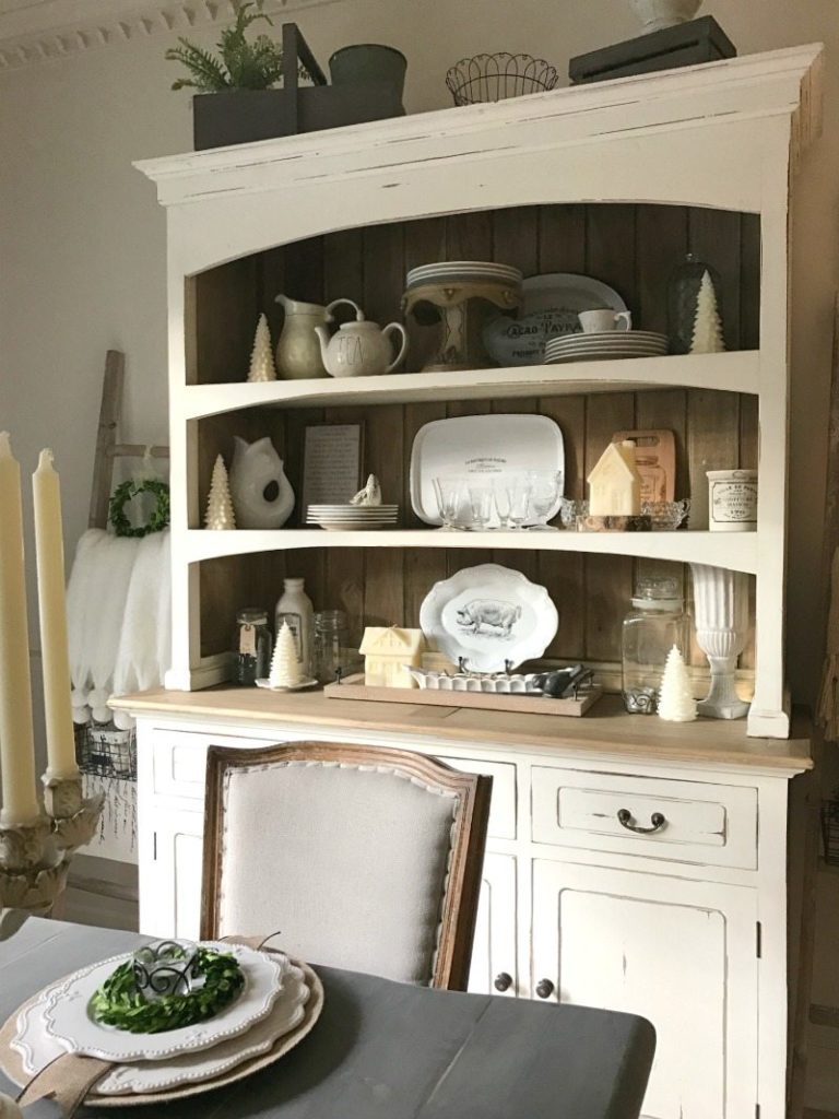 vintage plates, ironstone and antiques decorate farmhouse hutch