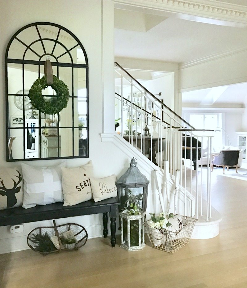front entryway decor with bench and window mirror