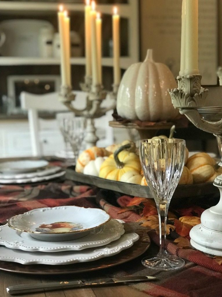 glamorous thanksgiving tablescape with glass pumpkins and candlesticks