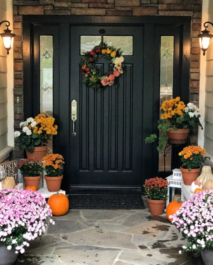 Fall porch decorated with mums and seasonal color for fall