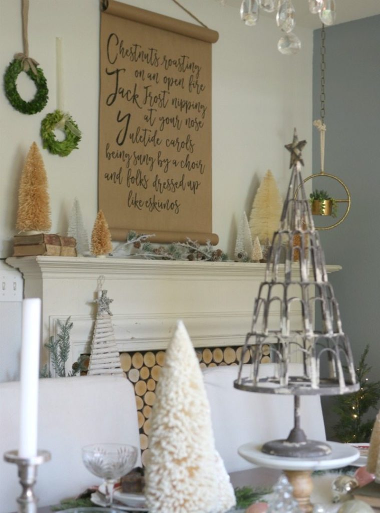 Create festive holiday table with hanging wreaths and DIY fireplace
