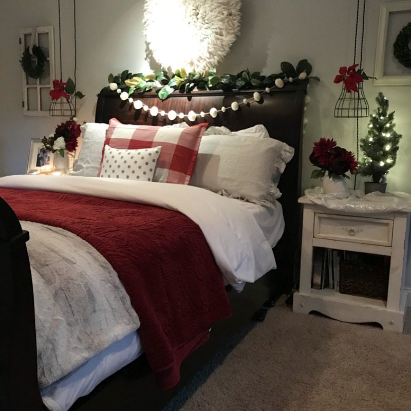 budget holiday decorating for your master bedroom with pom-pom garlands