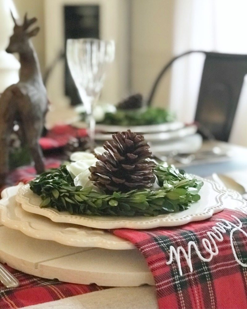 Holiday Home Tour Decorating for Christmas dining room with greenery and pinecones