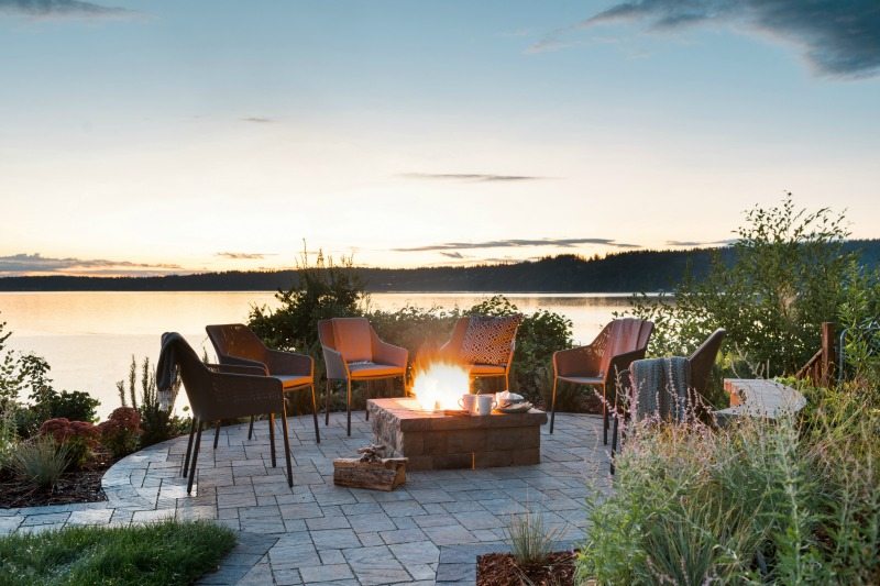 sunset lake view with firepit and chairs