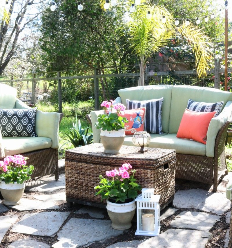 pretty outdoor oasis with pillows and flowers