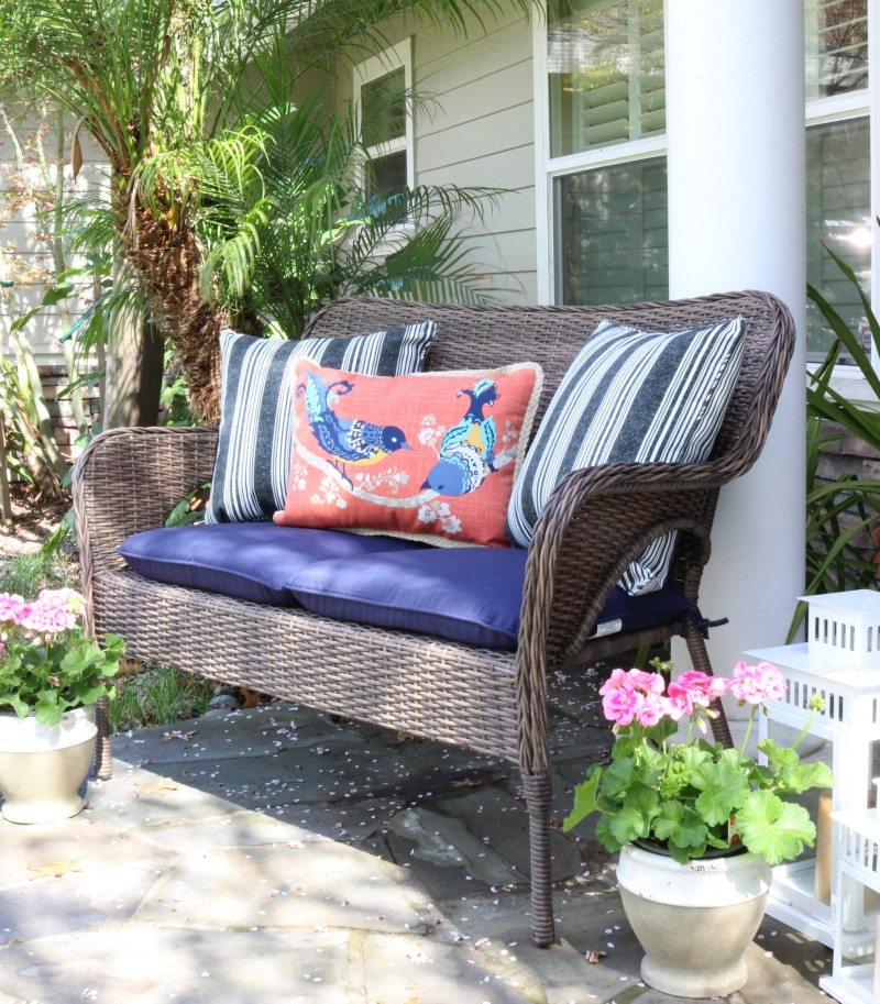 wicker bench pillows and flowers
