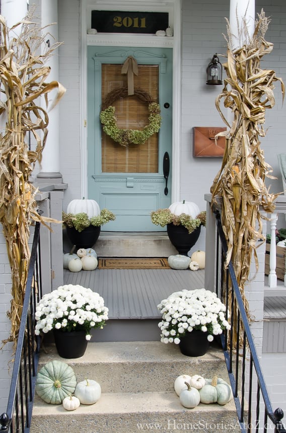 fall front steps with neutral and white pumpkins