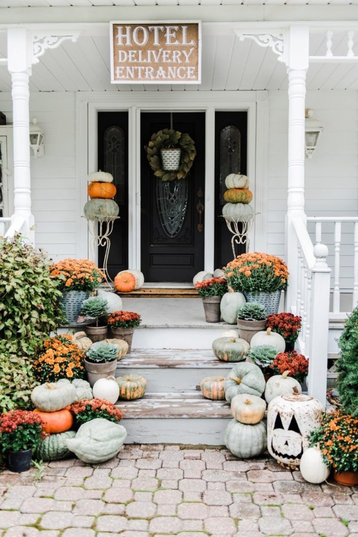 farmhouse fall front porch with pumpkins and mums