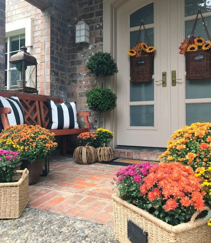fall front porch with pillows and mums