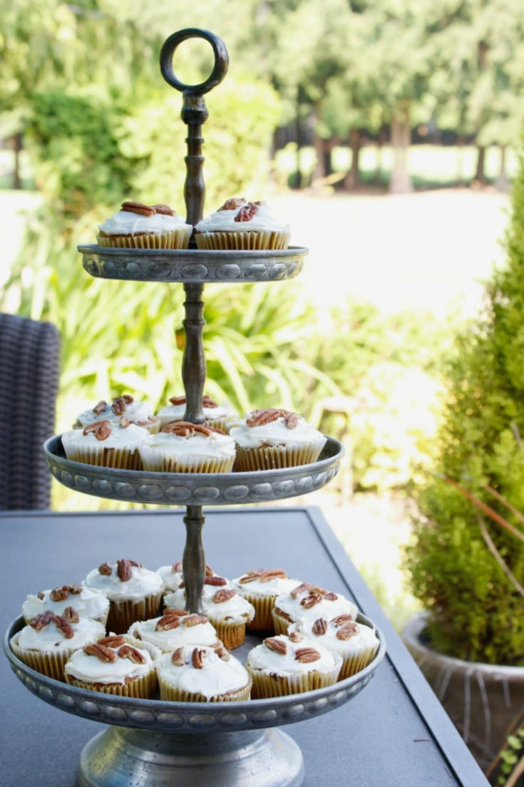 three tiered tray with pumpkin cupcakes