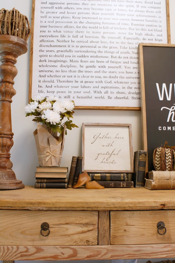farm table and farmhouse sign with vintage books as decor