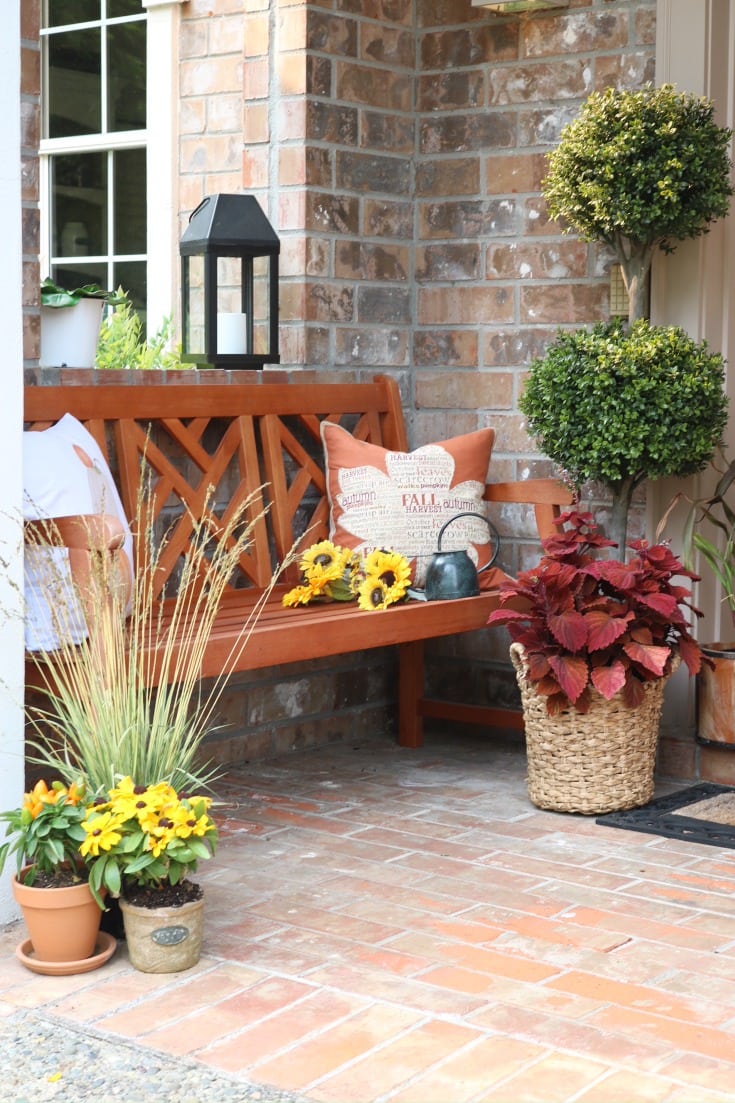 festive fall front porch with bench and mums