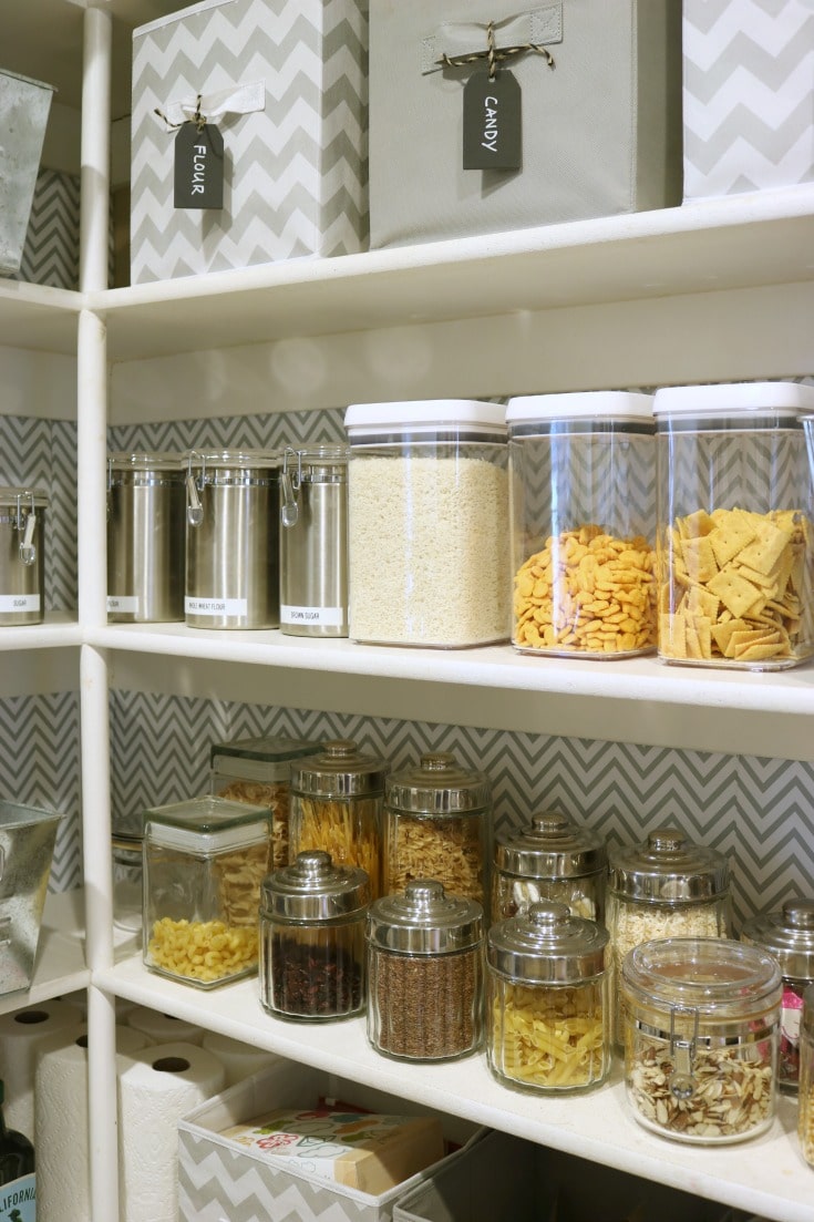 organized kitchen pantry shelves with clear food containers with labels