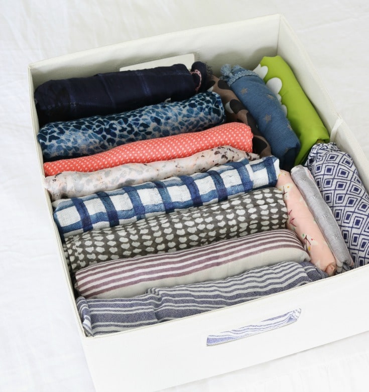 colorful folded organized scarves in bin using Marie Kondo organizing method