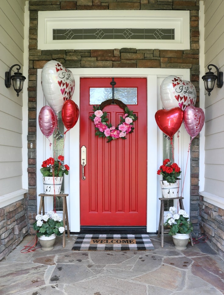 Create the most festive holiday door decor for Valentines day with a red door and balloons.