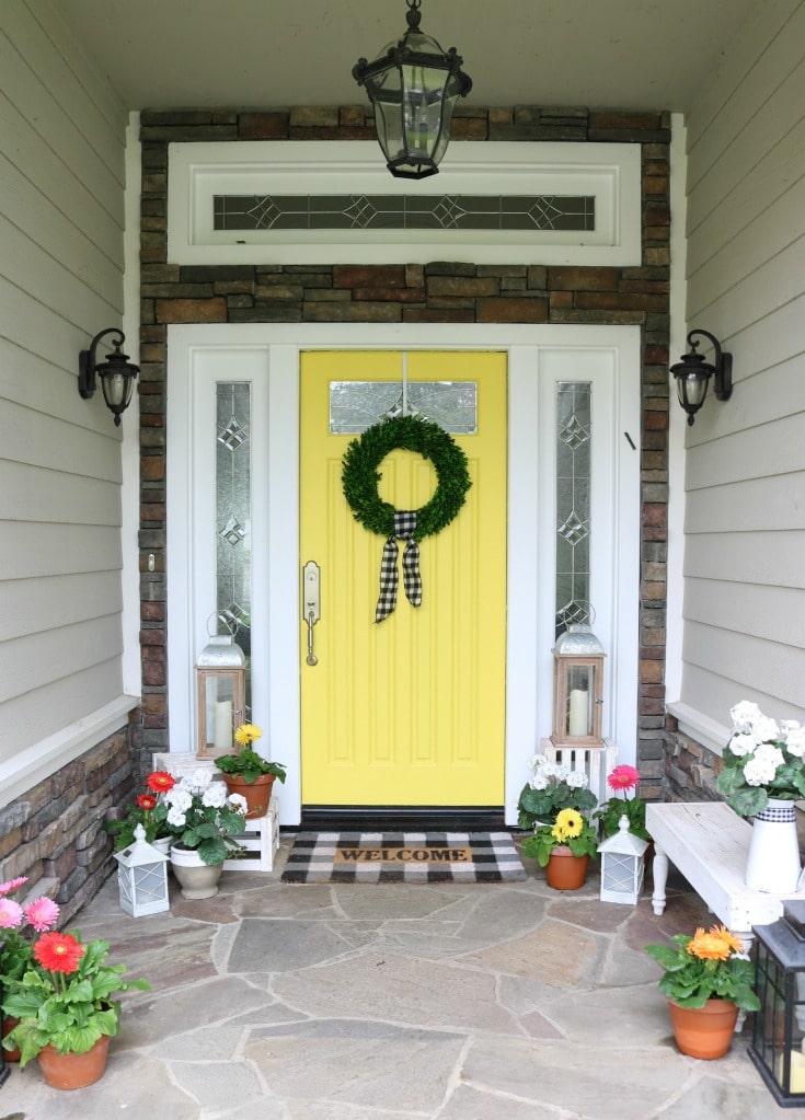 Decorate your front door with a bright bold paint color and fresh colorful flowers this spring.
