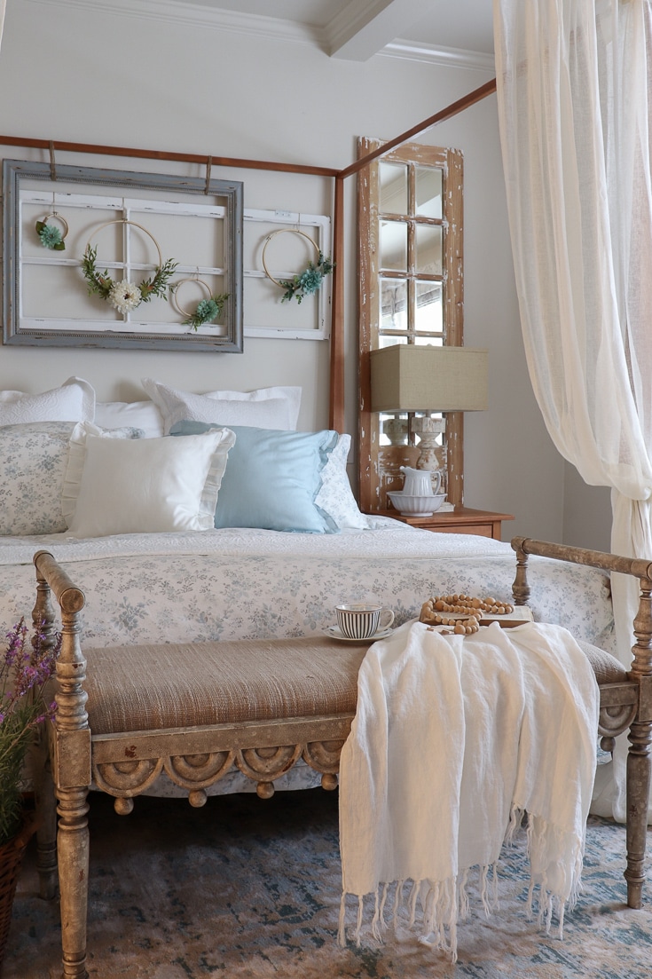 romantic canopy bed with floral bedding and rich fabrics
