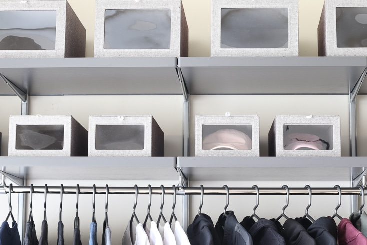 Gray finishes and stylish storage boxes make custom closet look great