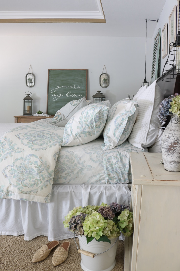 romantic bedroom details dried hydrangeas floral sheets and luxury bedding