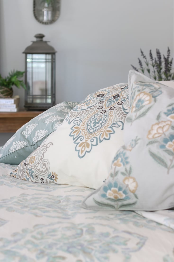 Bedding details with soft colors and textures lantern