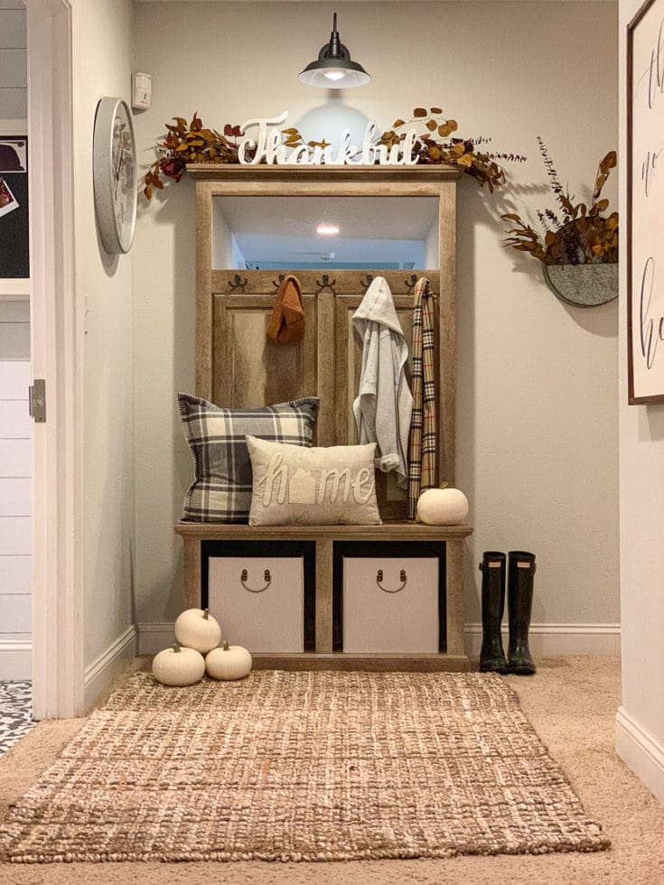 Organized hallway creates stylish entryway and functional storage with seasonal welcoming decor