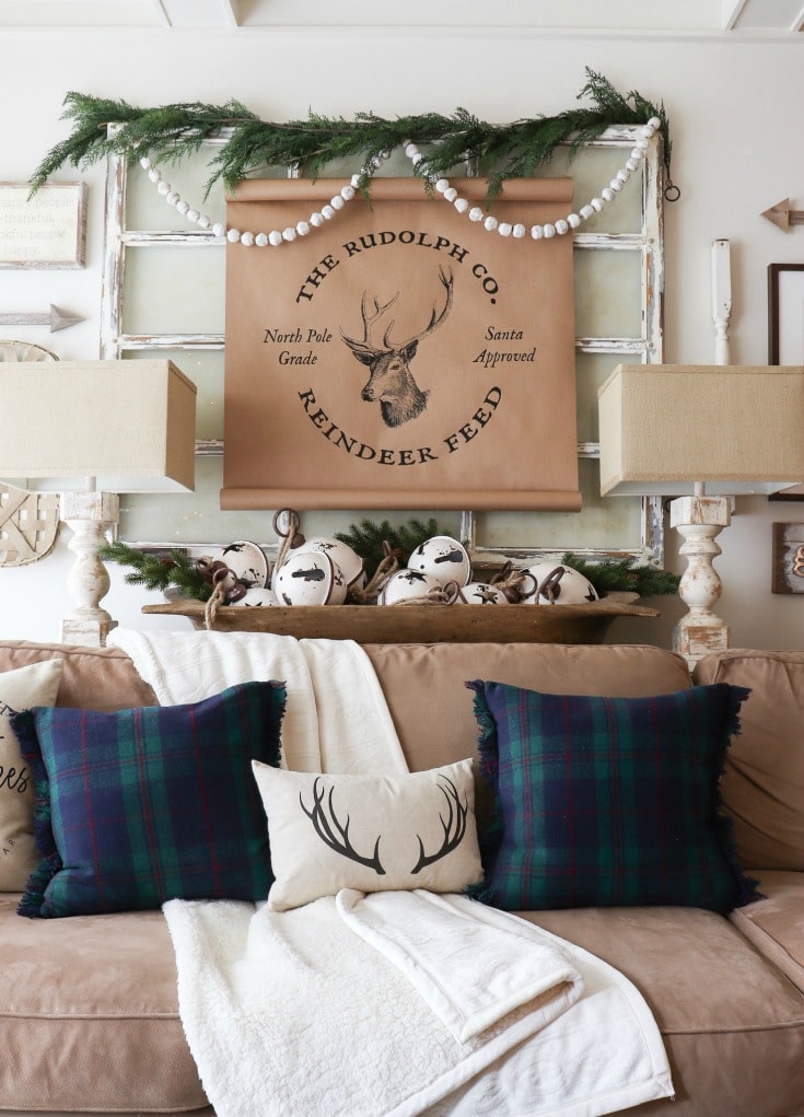 farmhouse reindeer sign with greenery and blue and green plaid pillows from Better Homes and Gardens at Walmart