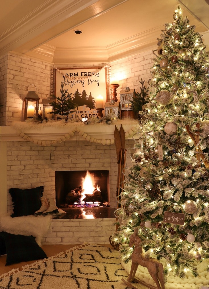 fireplace setting with pom-pom mantle garland and silver tree decorations