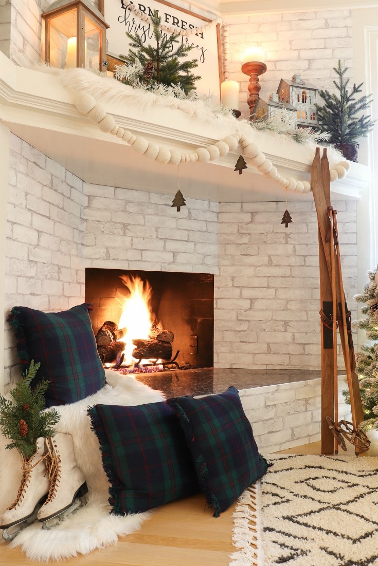 fireplace decor with farmhouse plaid pillows and vintage skis