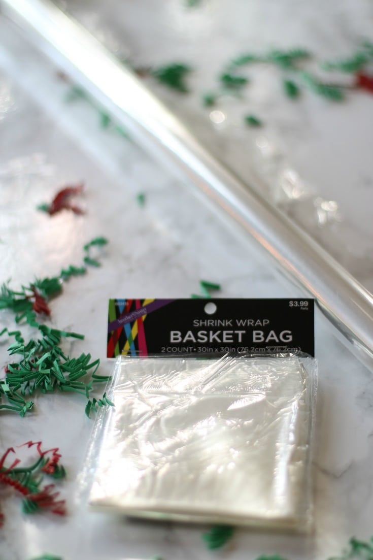 wrap your christmas gift baskets in clear cellophane and tie with festive red and green ribbon