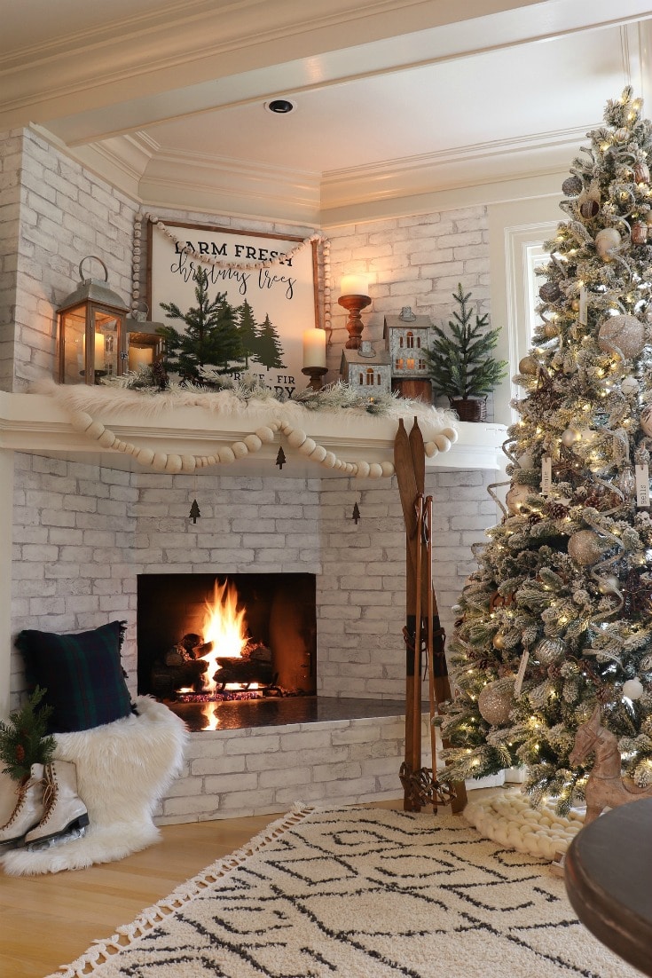 cozy White Christmas decor with fireplace and flocked tree