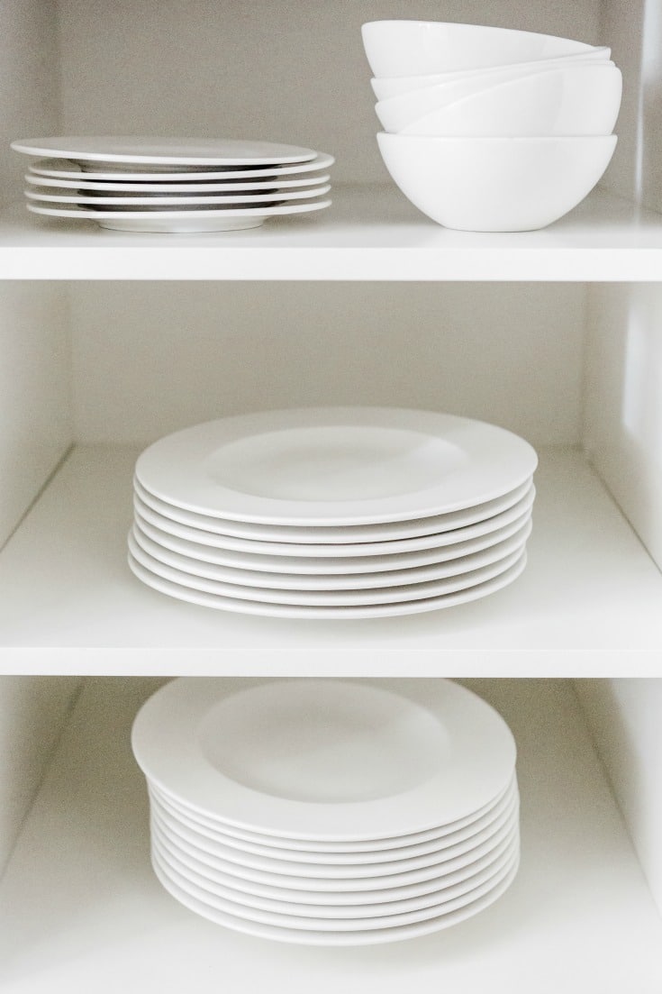 clean white dishes sitting on white shelves