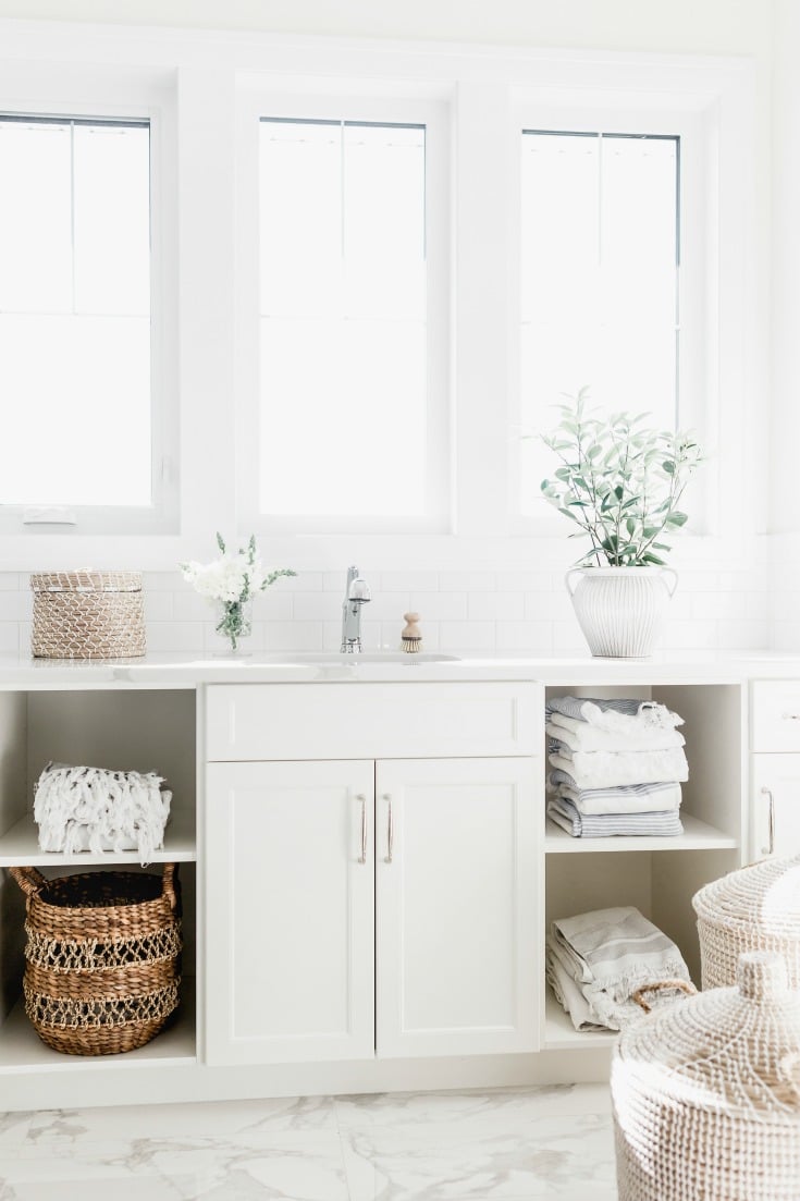 clean white bathroom with towels and sink