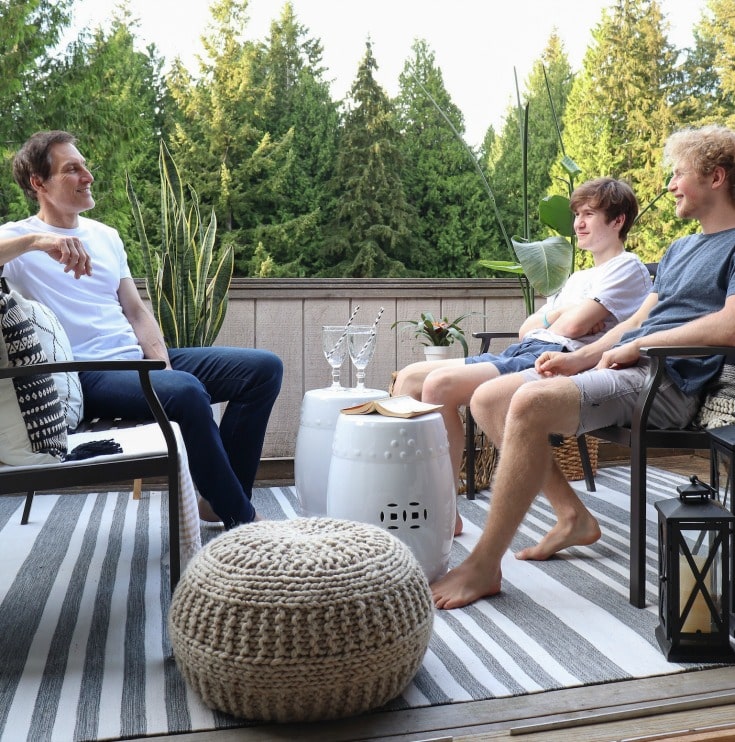 father and sons enjoying their new small patio space