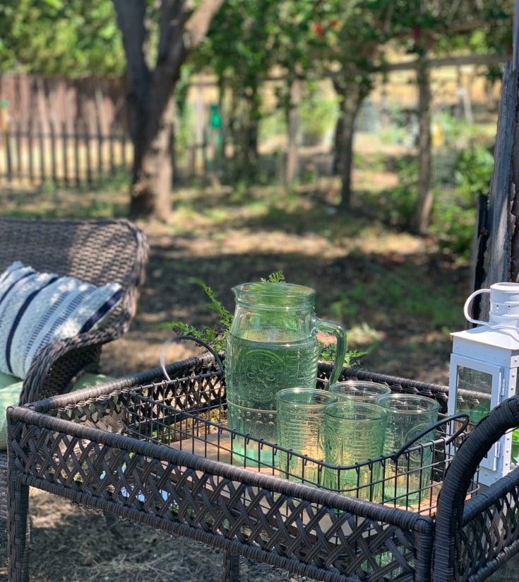 outdoor bar cart with green glassware