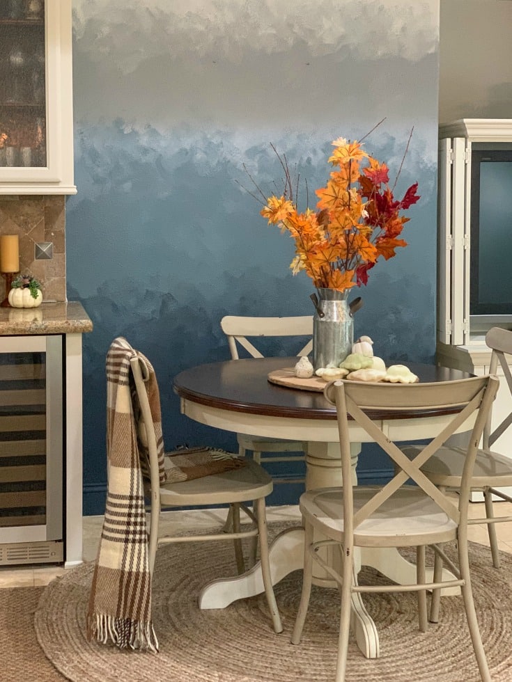 ombre wall with table and chairs and fall leaves
