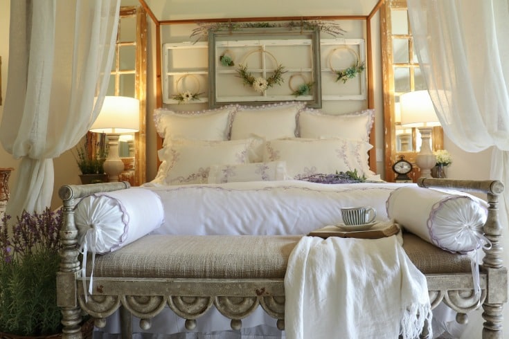 beautiful white bed with comfy pillows and blankets