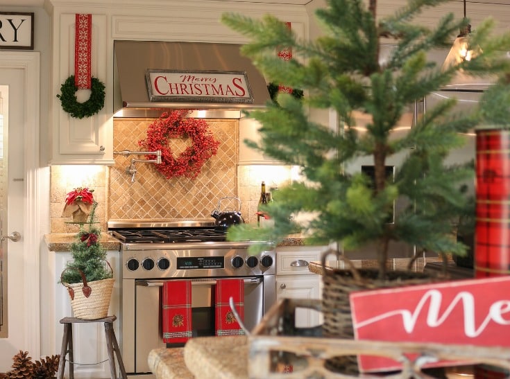 holiday kitchen with wreaths on cabinets