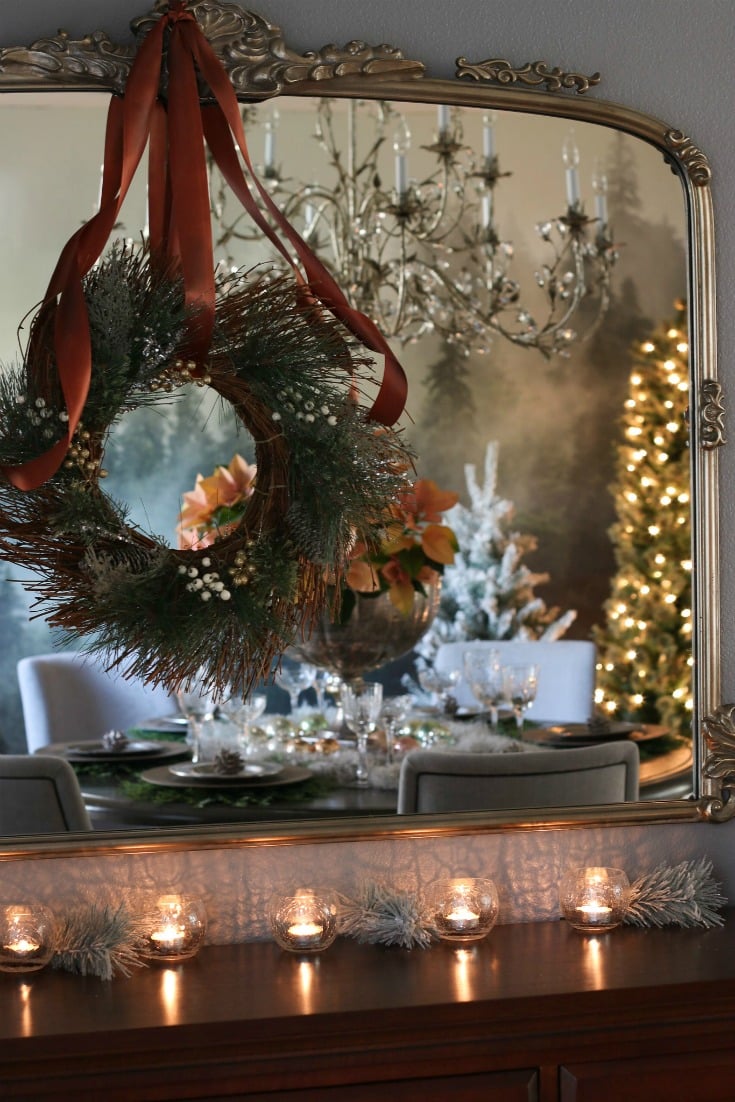 antique detailed mirror with holiday wreath reflecting beautiful festive dining room