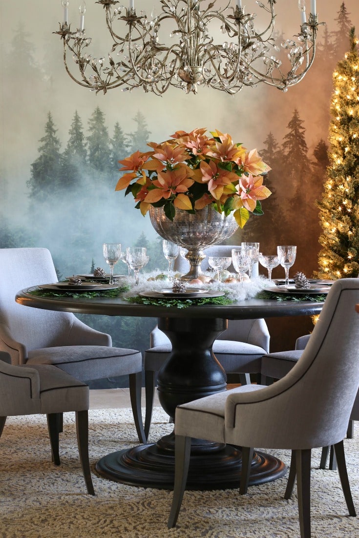 gorgeous dining room with forest mural pink poinsettia centerpiece crystal chandelier and grey upholstered chairs