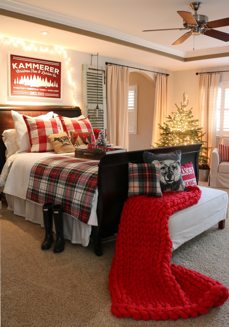 farmhouse christmas master bedroom with red plaid details and chunky blanket