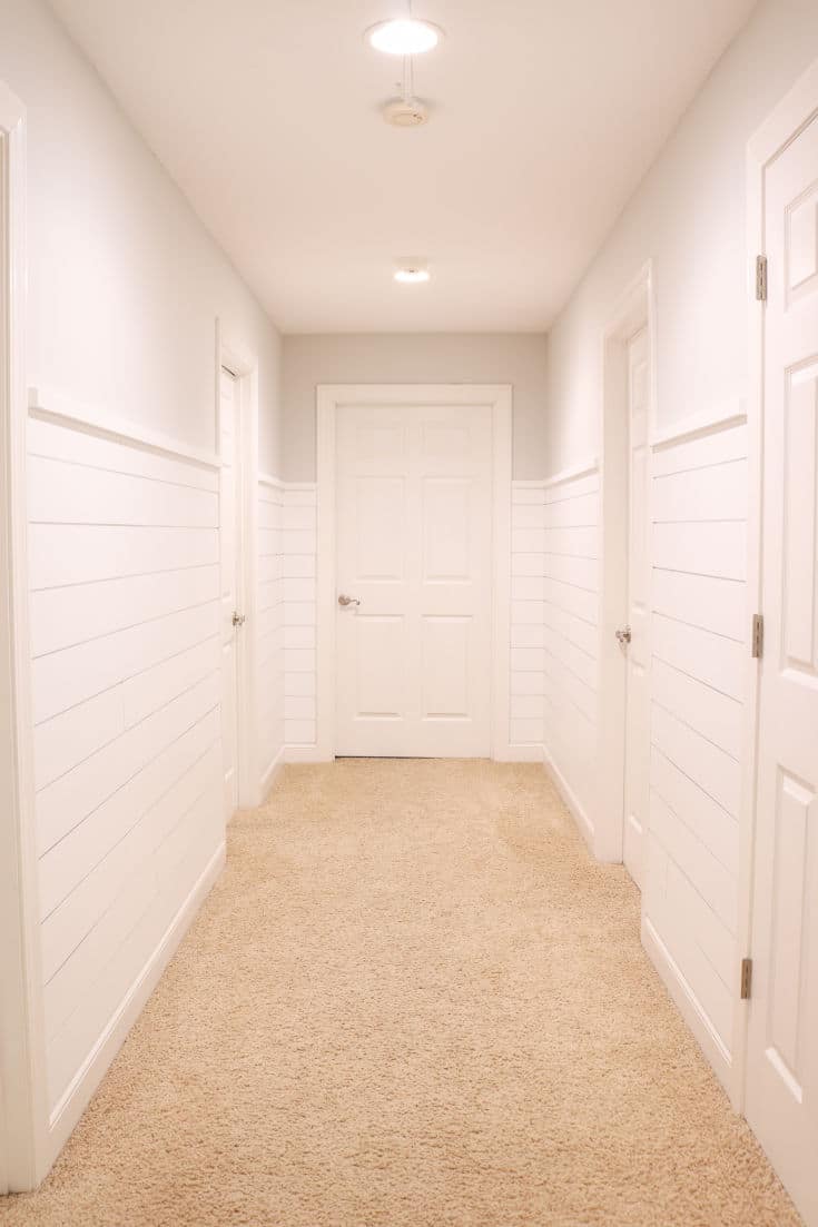 empty hallway with white shiplap on walls